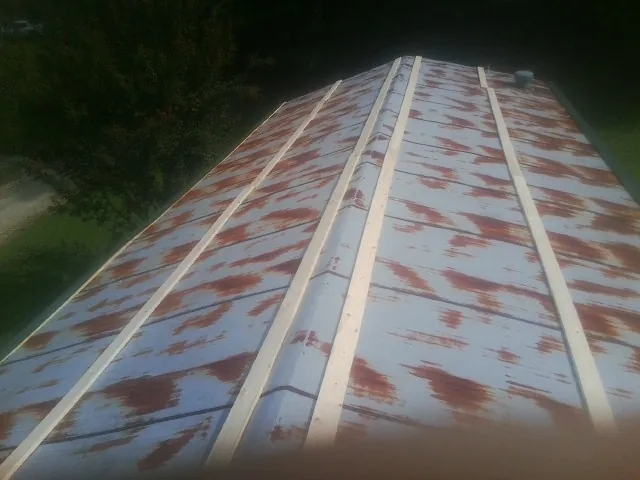 Rusted metal roof panels with new wood purlins before replacement — Storm Damage Roof Repair in Barclay by Roofing Brothers
