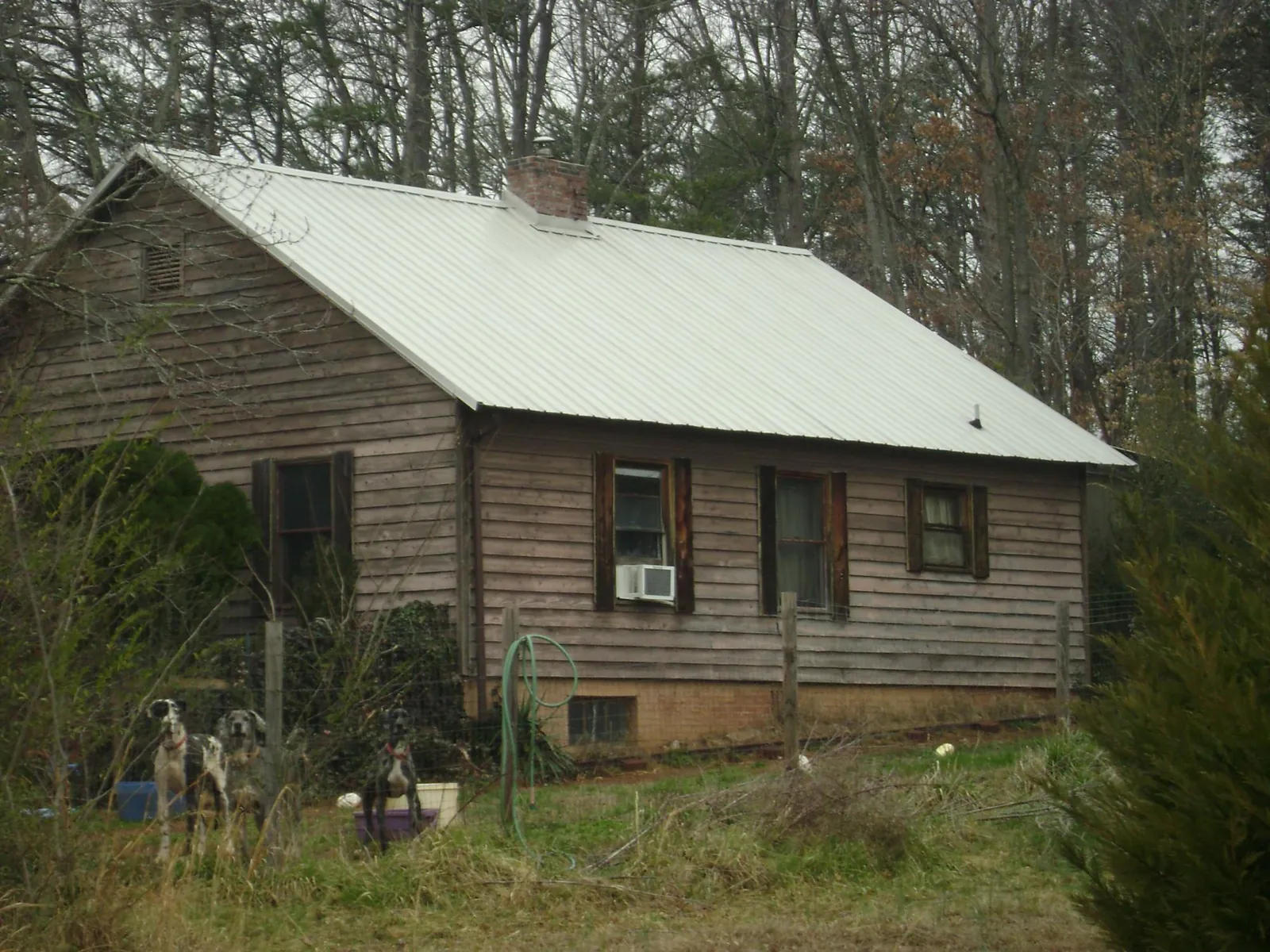 White metal roof on an old wood sided farmhouse, from a Metal Roof Installation job in Barclay